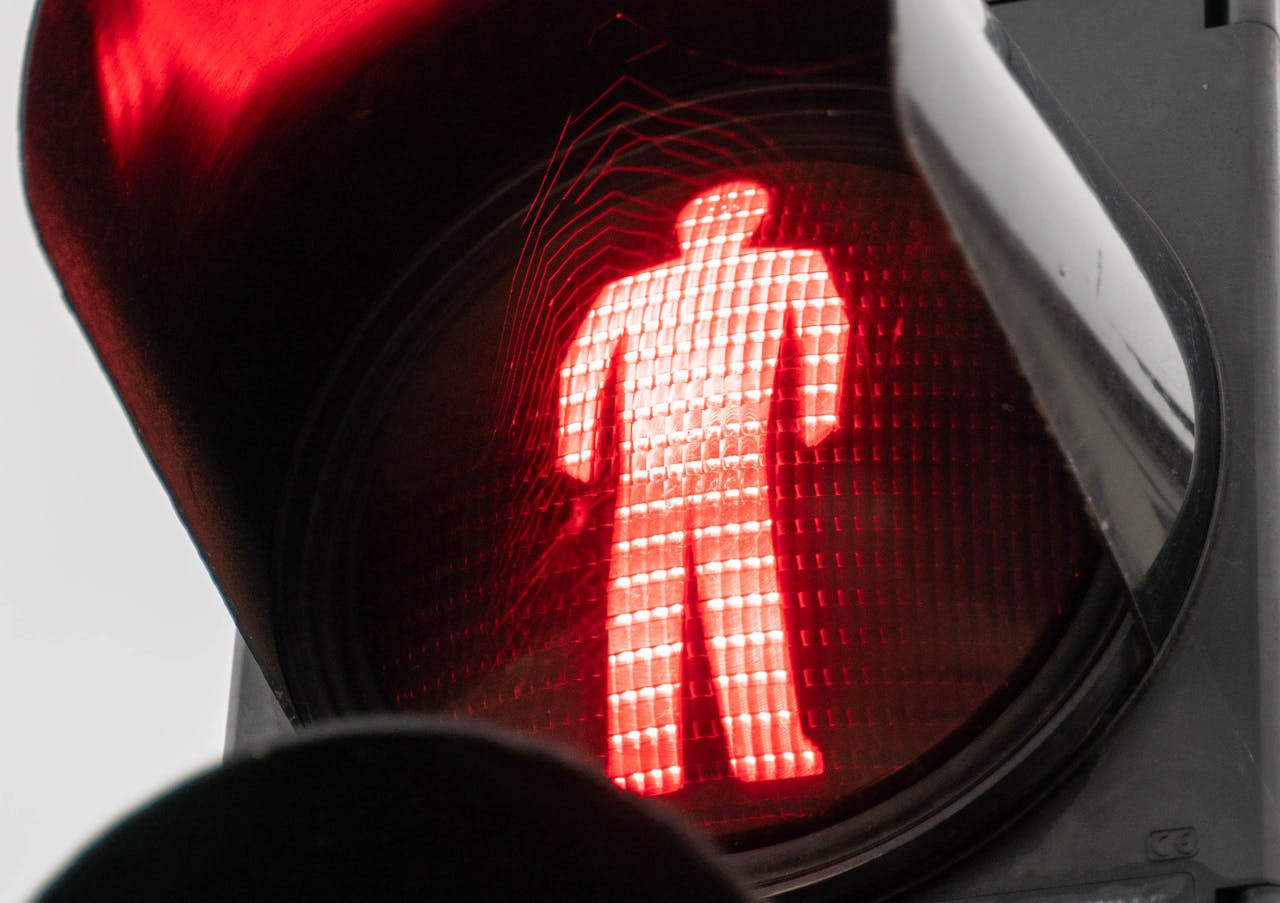 Mastering the First Impression: Your intriguing post title goes here Detailed view of a red pedestrian crossing signal indicating stop.